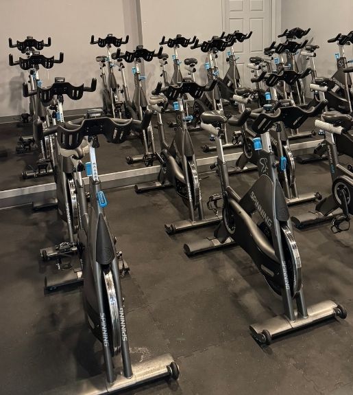 Indoor cycling studio at Powerhouse Gym Linden NJ with rows of spin bikes